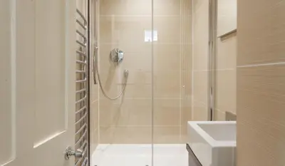 a bathroom with a shower and a toilet and a sink at Gorgeous Georgian townhouse in Moffat