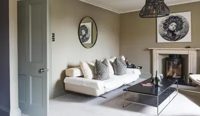 a living room with a white couch and a table at Gorgeous Georgian townhouse in Moffat