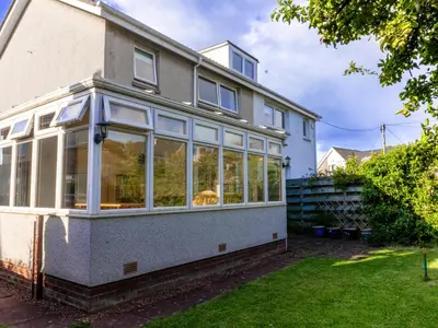 a house with large windows on the side of it at 3 Bedroom Home, Peaceful Garden in Edinburgh