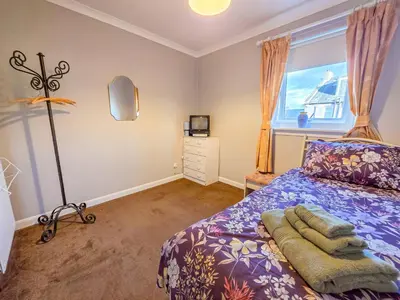 a bedroom with a bed and a window at 3 Bedroom Home, Peaceful Garden in Edinburgh