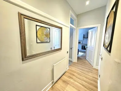 a hallway of a home with a painting on the wall at Sensational Stay- Fountainbridge in Edinburgh