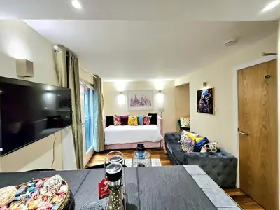 a living room with a bed and a couch at 2 bedroom, 4 beds -Grassmarket in Edinburgh