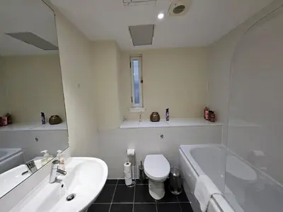 a bathroom with a tub and a toilet and a sink at 2 bedroom, 4 beds -Grassmarket in Edinburgh