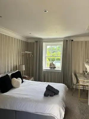 a bedroom with a large white bed and a window at Brig o Doon 3 in Ayr