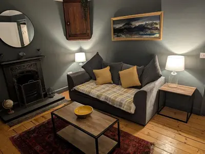 a living room with a couch and a table at Dean Village, Edinburgh in Edinburgh