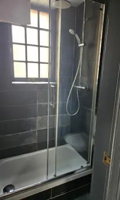 a shower with a glass door in a bathroom at Dean Village, Edinburgh in Edinburgh