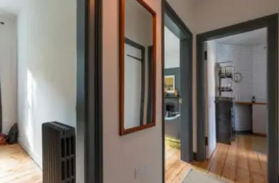 a room with a hallway with a mirror and a room with a kitchen at Dean Village, Edinburgh in Edinburgh