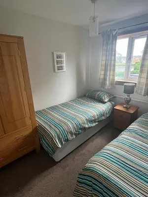 a bedroom with two twin beds and a window at 3 bed self contained part house in Queensferry, Edinburgh in Queensferry
