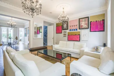 a living room with white furniture and a chandelier at The Victorian Residence in Moffat