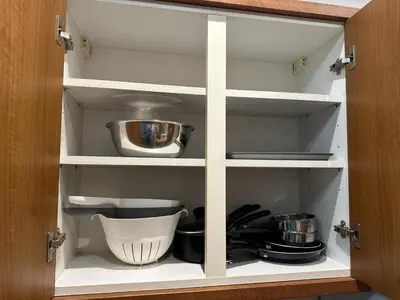 a cupboard with some kitchen utensils in it at City Centre Ground floor 3 Bedroom Apartment in Edinburgh