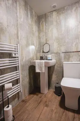 a bathroom with a sink and a toilet at Coat Apartment in Coatbridge