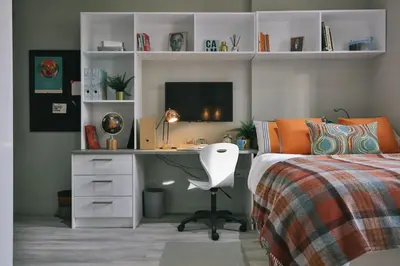 a bedroom with a bed and a desk with a computer at For Students Only - George Street in Glasgow in Glasgow