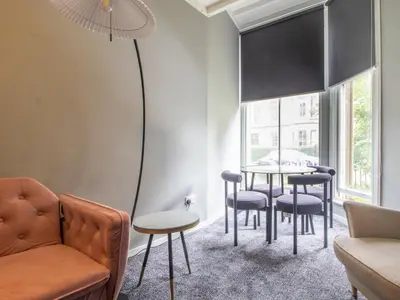 a living room with a table and chairs at Pass the Keys Cosy in Fabulous West End in Glasgow