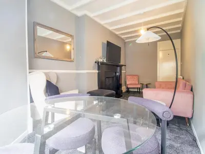a living room with a glass table and chairs at Pass the Keys Cosy in Fabulous West End in Glasgow