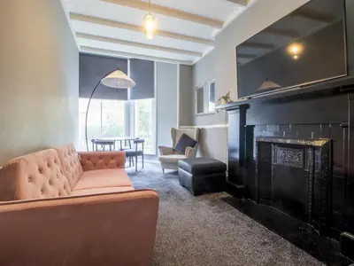 a living room with a couch and a fireplace at Pass the Keys Cosy in Fabulous West End in Glasgow