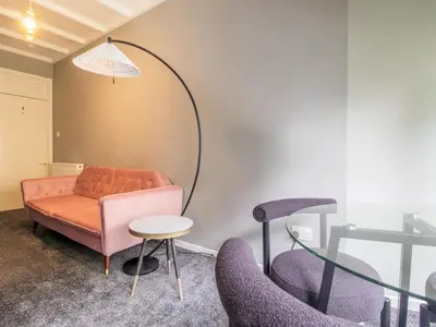 a room with a couch and chairs and a mirror at Pass the Keys Cosy in Fabulous West End in Glasgow