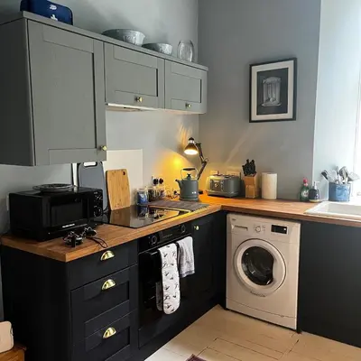 a kitchen with a stove and a washing machine at The Art Apartment in Kirn