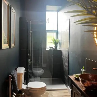 a bathroom with a shower and a toilet and a sink at The Art Apartment in Kirn