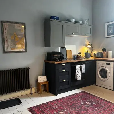 a kitchen with a sink and a washing machine at The Art Apartment in Kirn