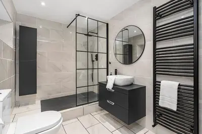 a bathroom with a toilet sink and a mirror at The Old Jail - Iconic Views in North Queensferry