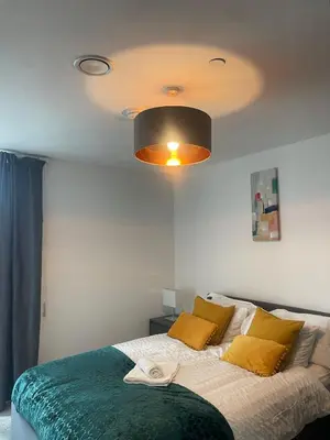 a bedroom with a large bed with a ceiling at The Bank Tower in Moffat