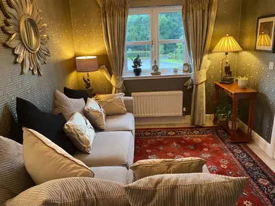 a living room with a couch and a window at Doune Duck Ponds Accommodation in Doune