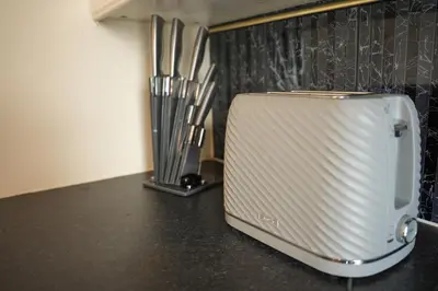 a toaster sitting on a counter in a kitchen at 2 BDR Apt At Caledonia Luxe Stays Short Lets & Serviced Accommodation Airdrie in Airdrie