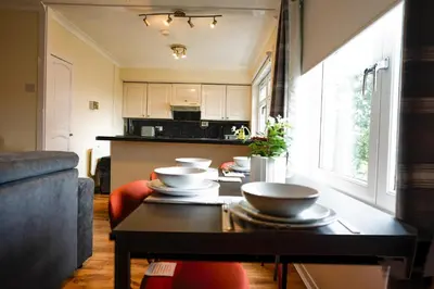 a living room with a table with bowls on it at 2 BDR Apt At Caledonia Luxe Stays Short Lets & Serviced Accommodation Airdrie in Airdrie