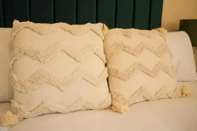 two pillows sitting on top of a bed at 3 BDR House By Caledonia Luxe Stays Short Lets & Serviced Accommodation Wishaw in Wishaw