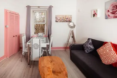 a living room with a couch and a table at Cosy Central Apartment by the Meadows 11 in Edinburgh