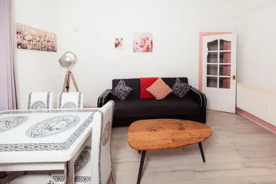 a living room with a couch and a table at Cosy Central Apartment by the Meadows 11 in Edinburgh