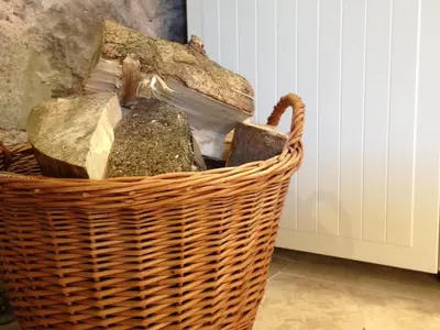 a wicker basket with some rocks in it at Buzzard Cottage nestled in a hillside farm in Stirling