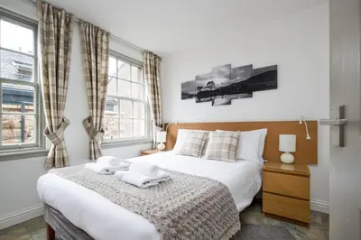 a bedroom with a bed with two towels on it at Grassmarket Apartment in Edinburgh