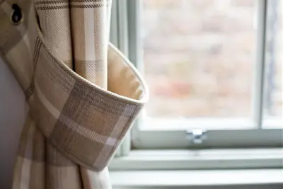 a close up of a curtain in front of a window at Grassmarket Apartment in Edinburgh
