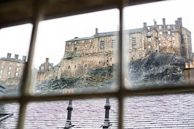 a view of a castle from a window at Grassmarket Apartment in Edinburgh