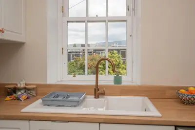 a kitchen counter with a sink and a window at Banrigh House in Stirling