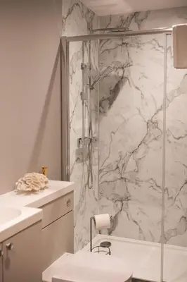 a bathroom with a shower and a toilet and a sink at Beechwood in Oban