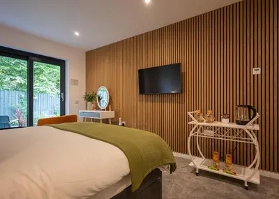 a bedroom with a bed and a tv on a wall at Beechwood in Oban