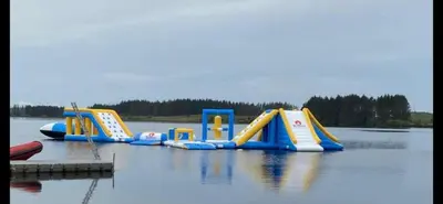 a group of inflatable slides in a body of water at Three lochs holiday park Loch view 123 in Balminnoch