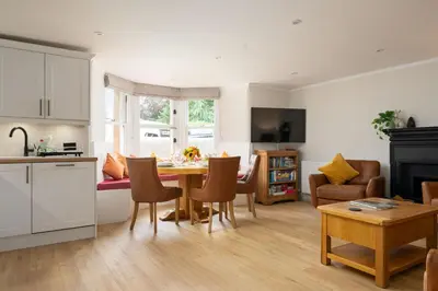a kitchen and living room with a table and chairs at Escape to Serene Georgian Estate, near Edinburgh in Ratho