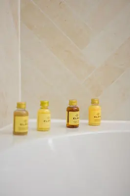 four bottles of honey sitting on a shelf in a bathroom at Escape to Serene Georgian Estate, near Edinburgh in Ratho