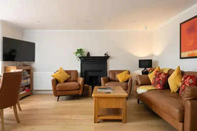 a living room with a couch and chairs and a fireplace at Escape to Serene Georgian Estate, near Edinburgh in Ratho