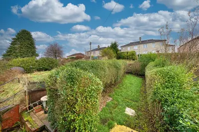 a garden with hedges and a house in the background at 3BR Flat Near Maryhill Park and West End with Parking in Partick