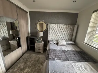 a bedroom with a bed and a large mirror at LUXERY 1 Bedroom Apartment - Falkirk in Falkirk