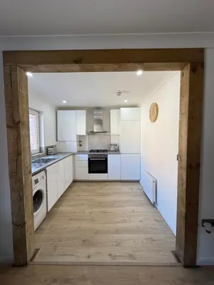a kitchen with white cabinets and a washer and dryer at Luxurious 2 bedroom, 8 mins from city centre in Glasgow