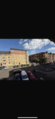 a view of a parking lot with parked cars and buildings at Luxurious 2 bedroom, 8 mins from city centre in Glasgow