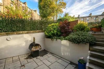 a garden with a fireplace and some plants at Elegant Flat with Garden in Edinburgh West End in Edinburgh