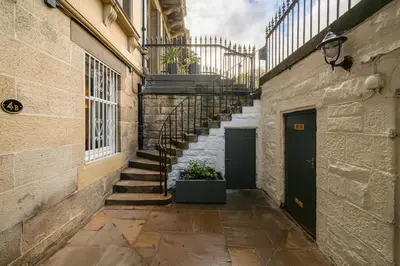 an alley with stairs and a door in a building at Elegant Flat with Garden in Edinburgh West End in Edinburgh