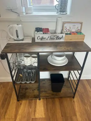a wooden table with a shelf with a box on it at Muirside Cottage in Stirling