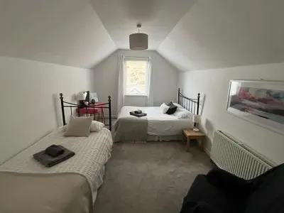 a bedroom with two beds and a window at Allt-Na-Craig Coach House - Ardrishaig in Ardrishaig